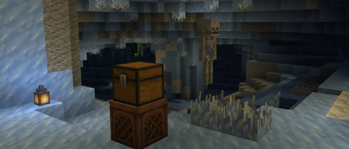 A jukebox with a chest on top in an ice cave, next to icicles and a skeleton